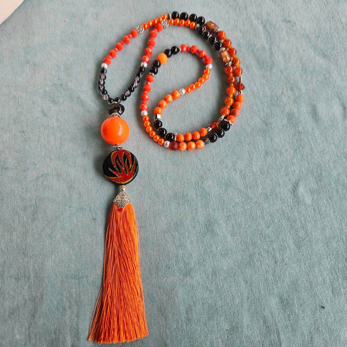 Halskette mit Perlen orange und Anhänger mit Quaste
